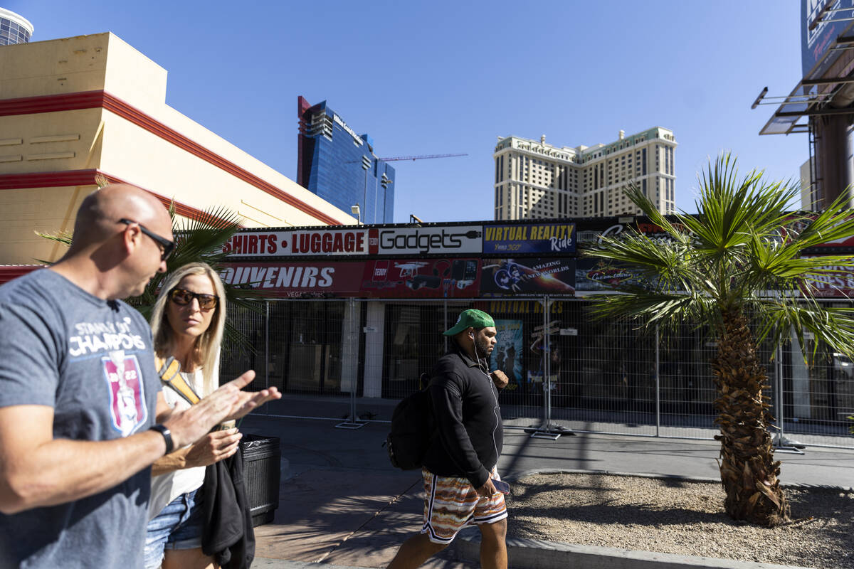 People walk in front of the shuttered souvenir shops at 3729 Las Vegas Blvd. South, in Las Vega ...