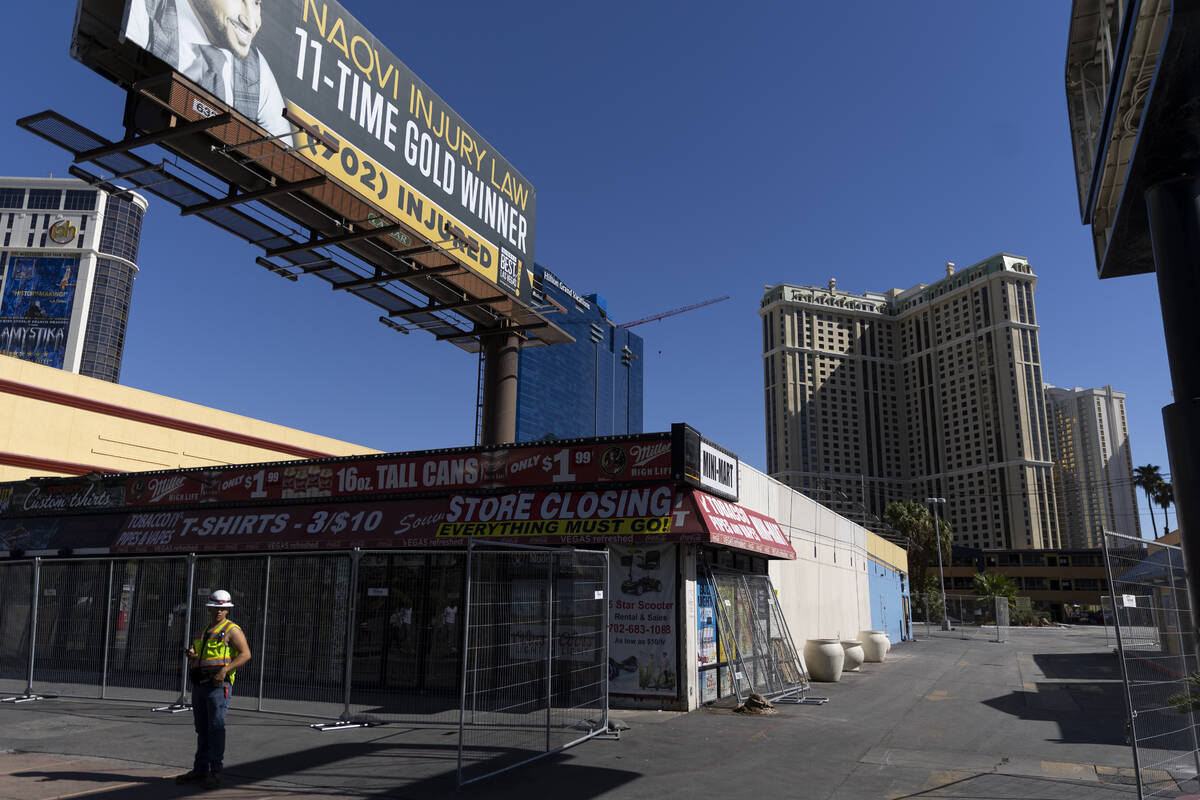 A person stands in of the shuttered souvenir shops at 3729 Las Vegas Blvd. South, in Las Vegas, ...