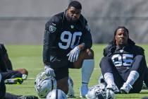 Raiders defensive tackles Johnathan Hankins (90) and Kendal Vickers (95) stretch during practic ...