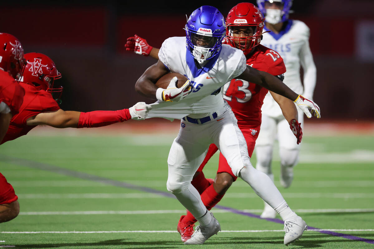 Bishop Gorman's Zachariah Branch (1) is tackled by Arbor View's Kade DeSantis (8) in the first ...