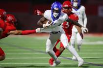 Bishop Gorman's Zachariah Branch (1) is tackled by Arbor View's Kade DeSantis (8) in the first ...