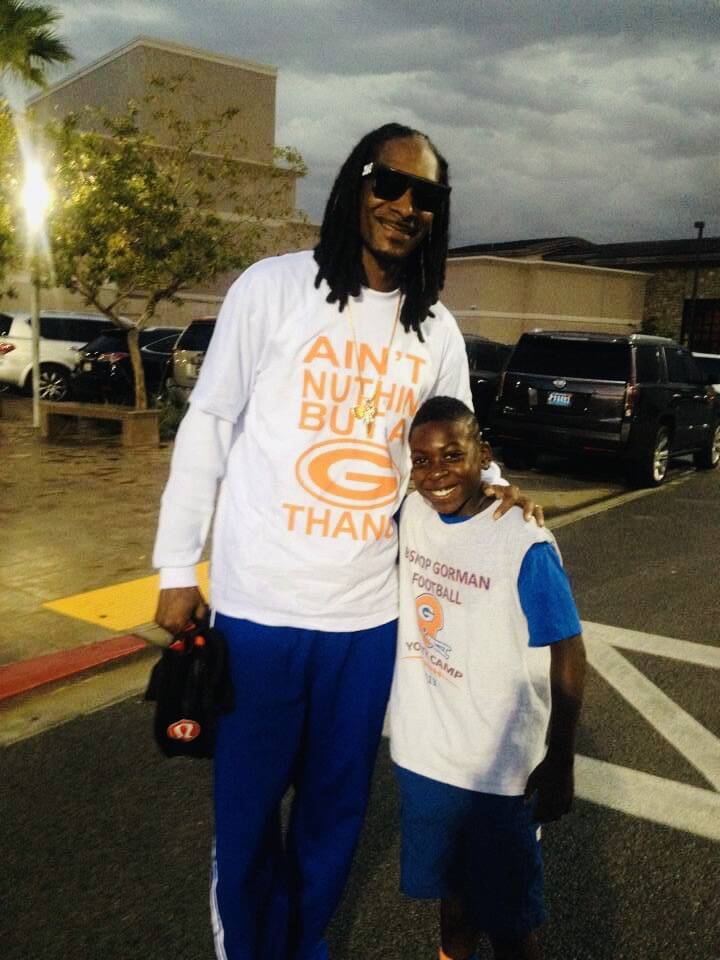 Zachariah Branch poses for a photo with recording artist and cultural icon Snoop Dogg after a B ...