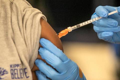 FILE - Medical personnel vaccinate students at a school in New Orleans on Tuesday, Jan. 25, 202 ...