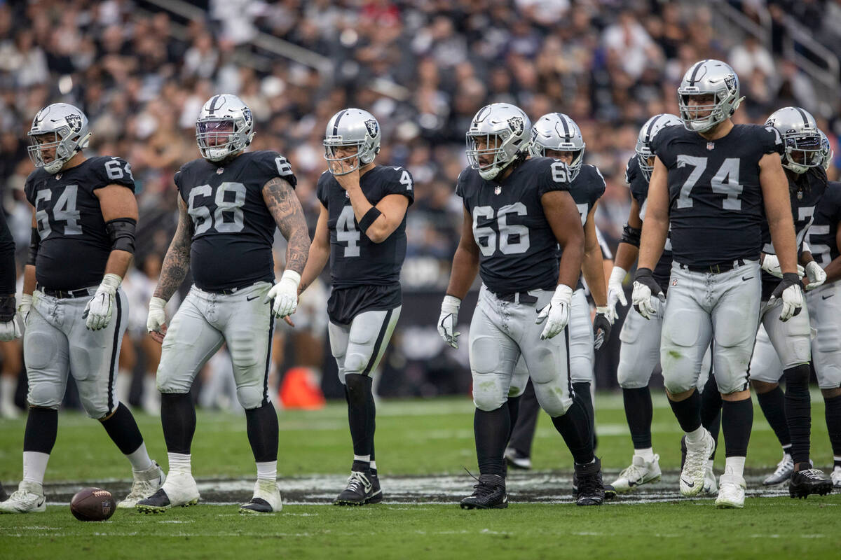 Raiders guard Alex Bars (64), center Andre James (68), quarterback Derek Carr (4), offensive li ...