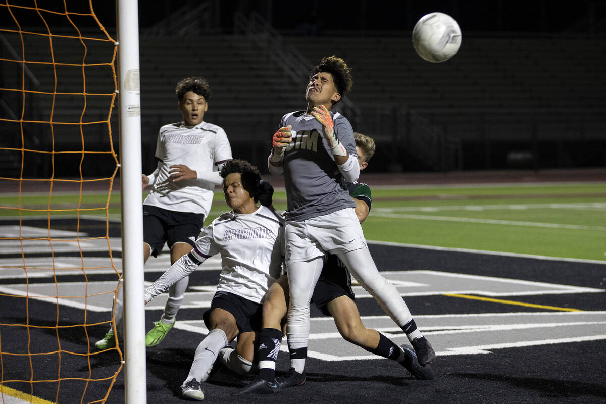 Palo Verde’s Preston Mendenhall collides with Cimarron-Memorial’s George Ruiz and ...