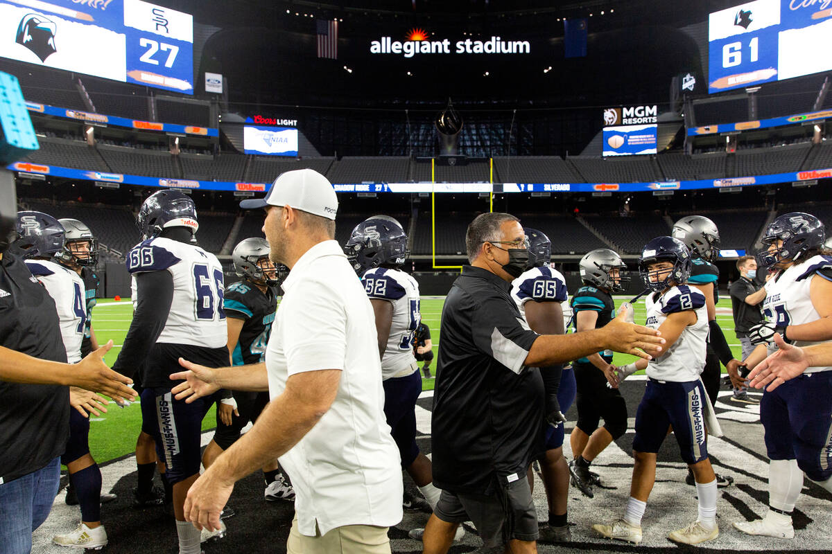 Shadow Ridge head coach Travis Foster and Silverado head coach Alejandro Ostolaza shake hands a ...