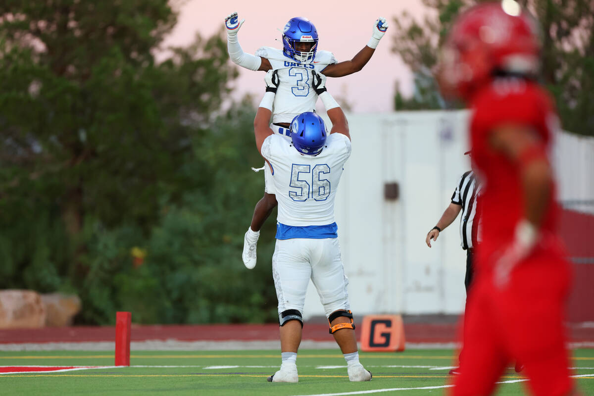 Bishop Gorman's Devon Rice (3) celebrates his touchdown run with Misiolo Maluia (56) against Ar ...