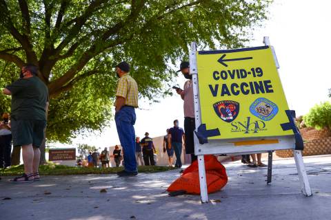 People wait in line at the COVID-19 vaccination site at Cashman Center in Las Vegas on Tuesday, ...