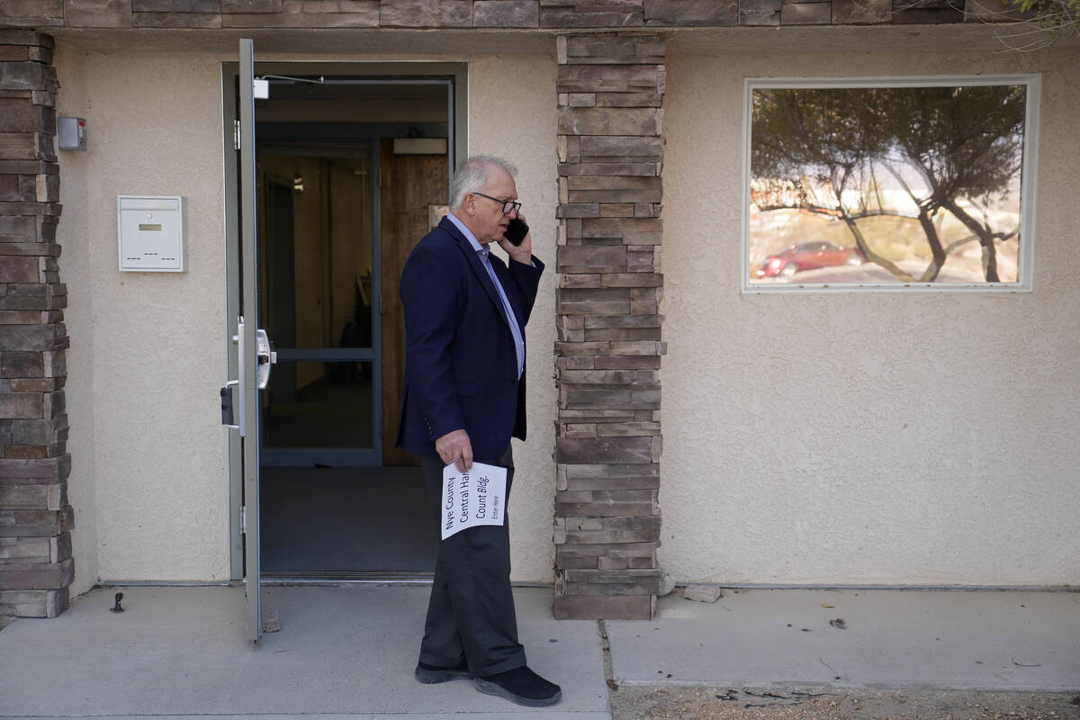 Interim Nye County Clerk Mark Kampf speaks on the phone outside of a building where early votes ...