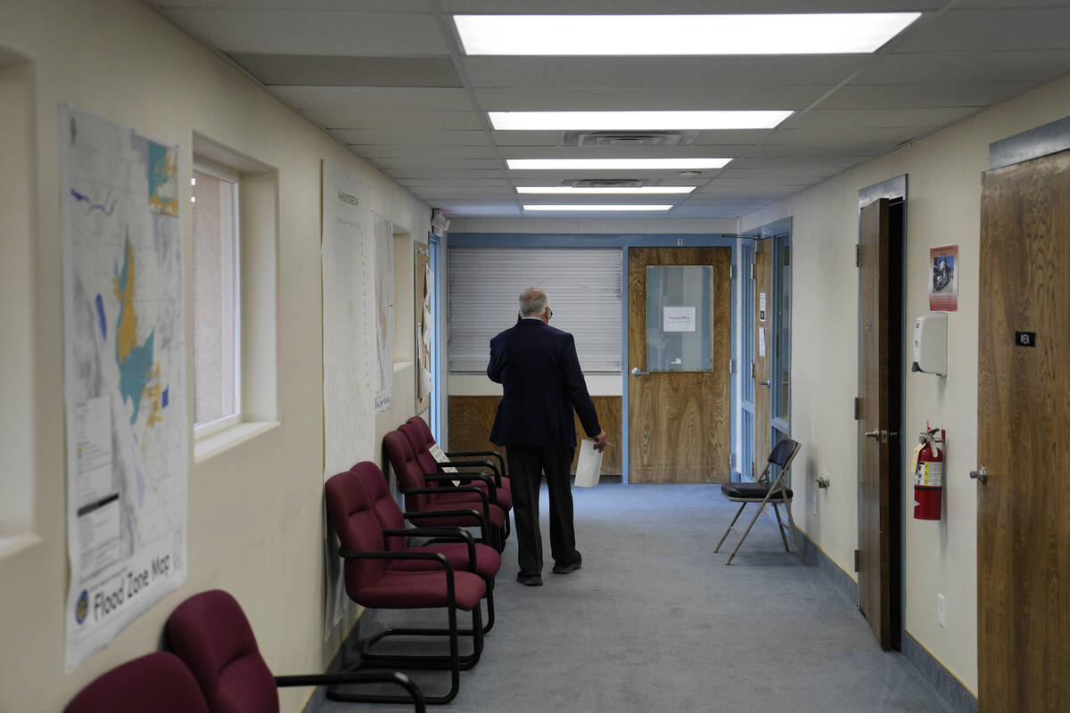 Interim Nye County Clerk Mark Kampf walks down a hallway at an office where early votes are bei ...