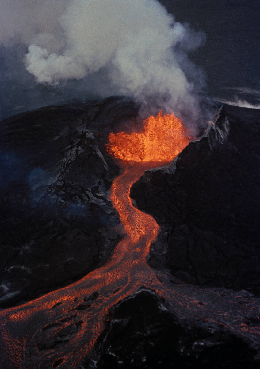 FILE - Lava flows downhill from the crater of Mauna Loa, April 5, 1984, on the island of Hawaii ...