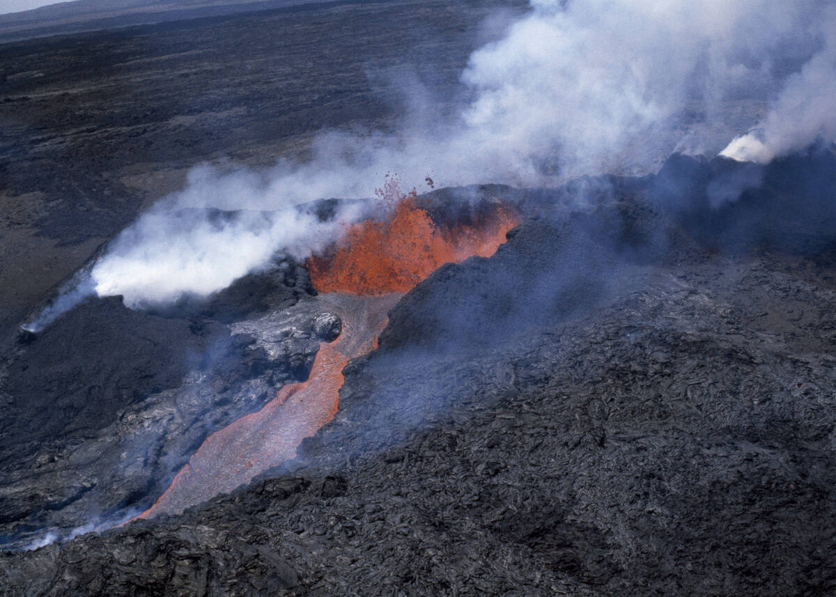 FILE - Molten rock flows from Mauna Loa, located on the south-central part of the island of Haw ...