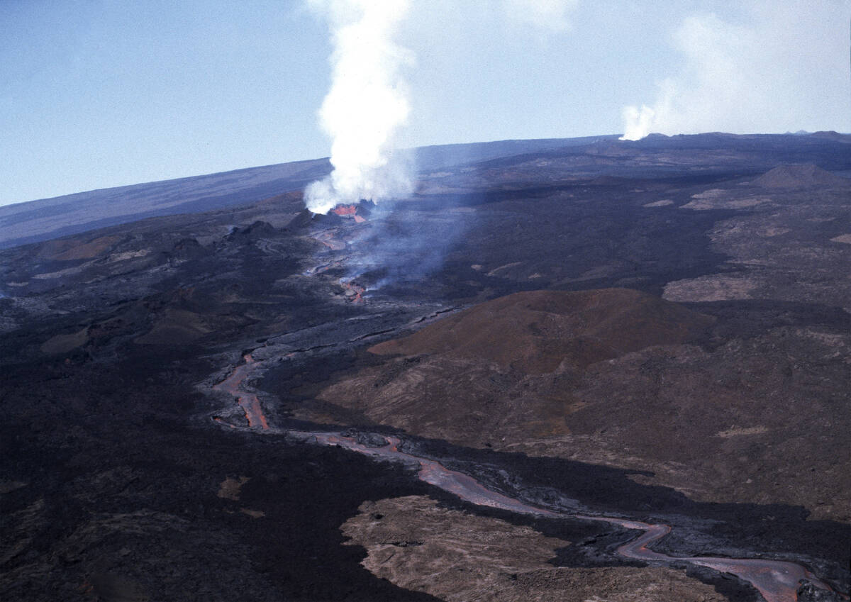 FILE - Molten rock flows from Mauna Loa, located on the south-central part of the island of Haw ...