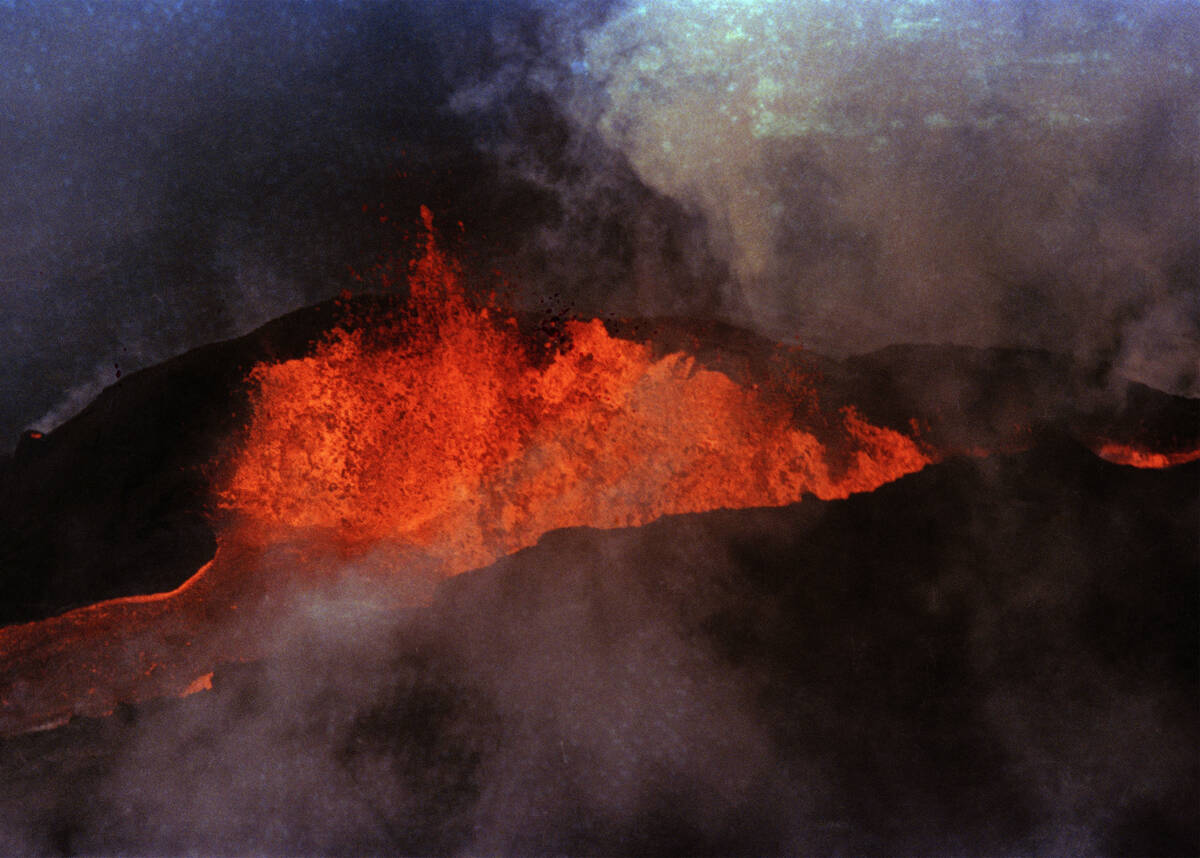 FILE - Molten rock flows from Mauna Loa on March 28, 1984, near Hilo, Hawaii. Hawaii officials ...