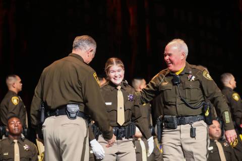Officer Stephen Kircher, right, stands with his daughter and academy graduate Kirsten Kircher, ...
