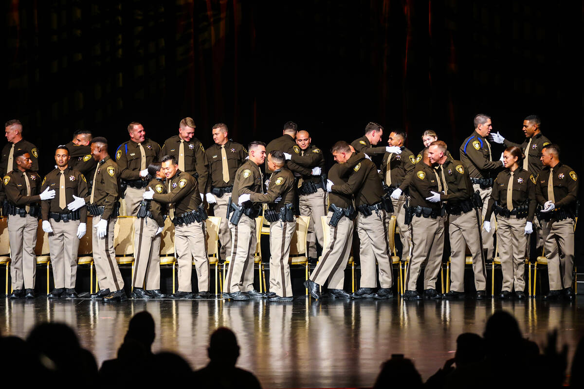 Newly sworn-in officers congratulate one another at the Metropolitan Police Department’s grad ...