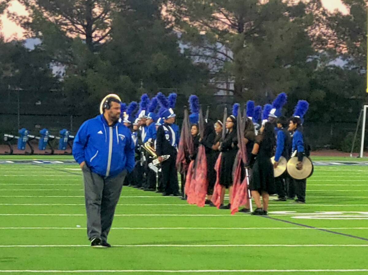 Desert Pines coach Tico Rodriguez walks on the field shortly before his team's playoff game aga ...