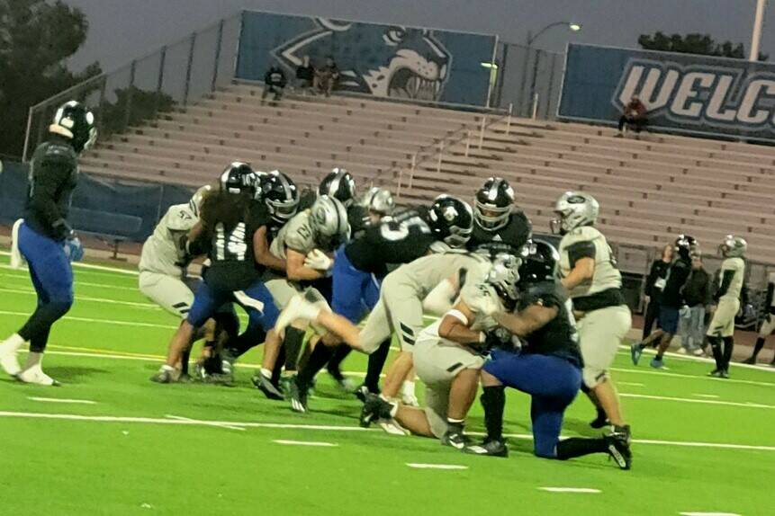 Palo Verde running back Blair Thayer is tackled by a Desert Pines defender during a playoff gam ...