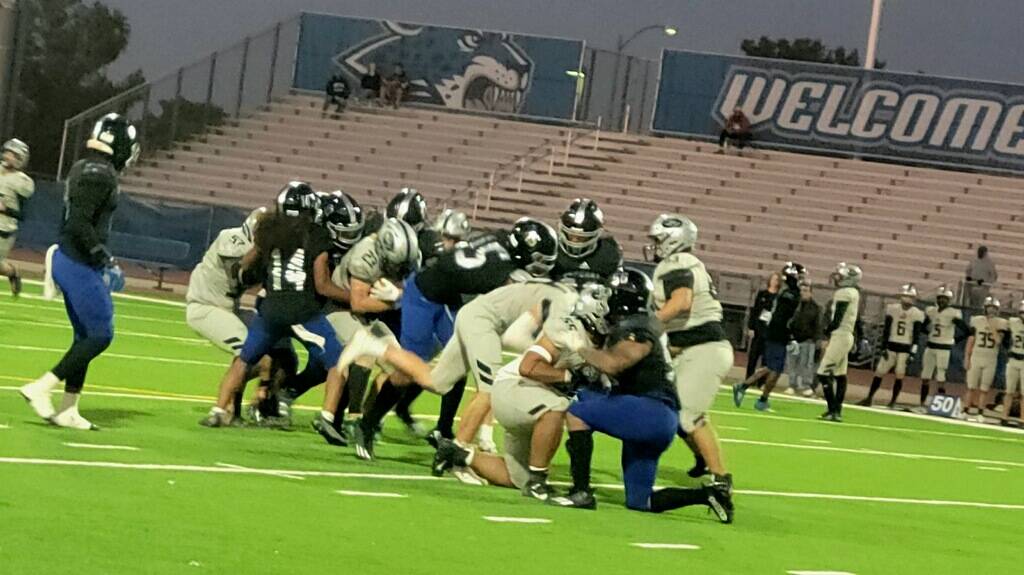 Palo Verde running back Blair Thayer is tackled by a Desert Pines defender during a playoff gam ...