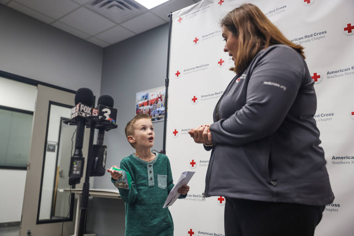 Henry Williams, 6, left, talks to Rachel Flanigan, executive director of the Red Cross of South ...