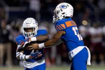 Bishop Gorman quarterback Micah Alejado (13) passes the ball to running back DeVon Rice (3) dur ...