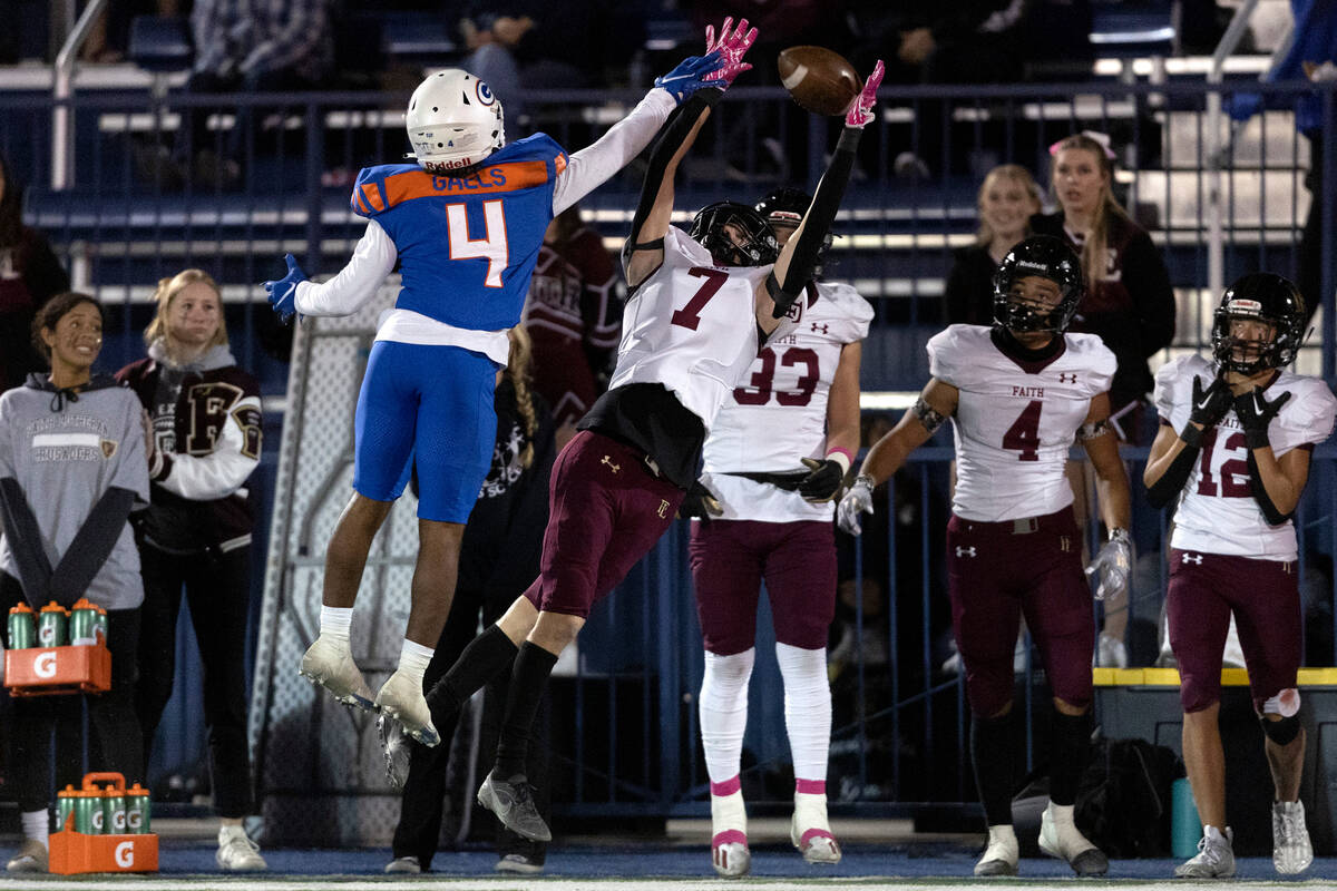 Faith Lutheran’s Mason Aday (7) jumps to catch a pass while Bishop Gorman’s Elija ...