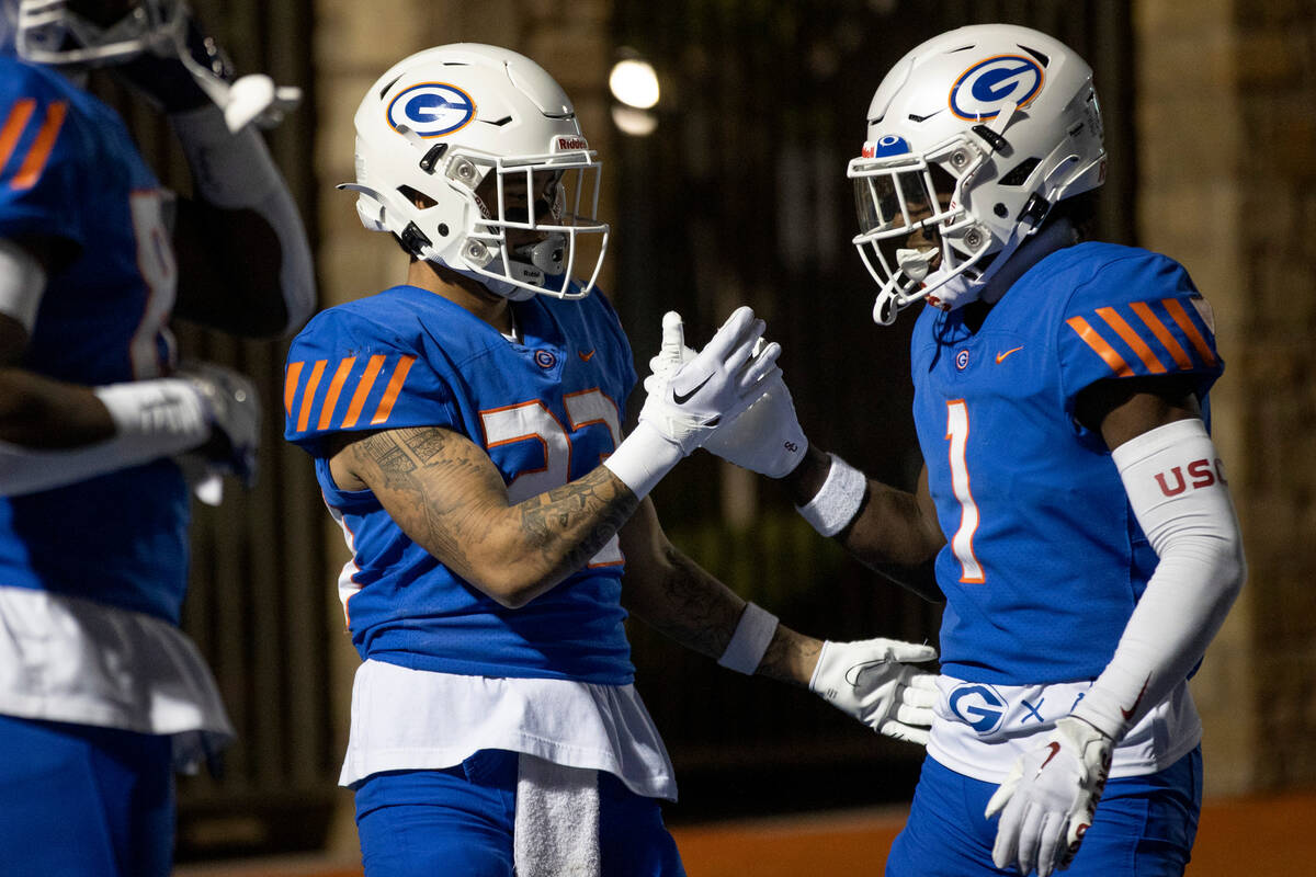 Bishop Gorman’s Trech Kekahuna (23) and Zachariah Branch (1) celebrate a touchdown durin ...