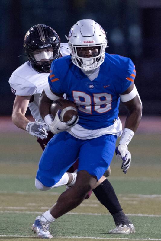 Bishop Gorman’s Jett Washington (88) looks for a pathway while Faith Lutheran’s M ...