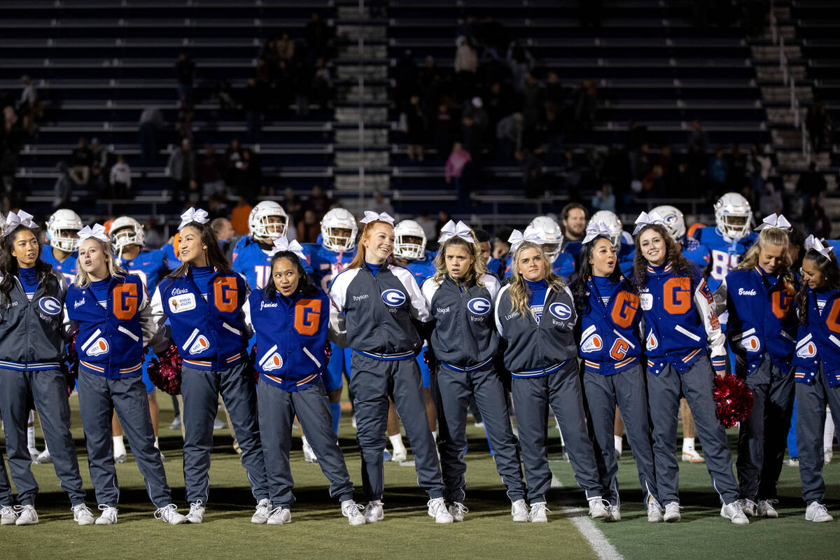 Bishop Gorman cheerleaders and team line up to sing their fight song after winning a high schoo ...