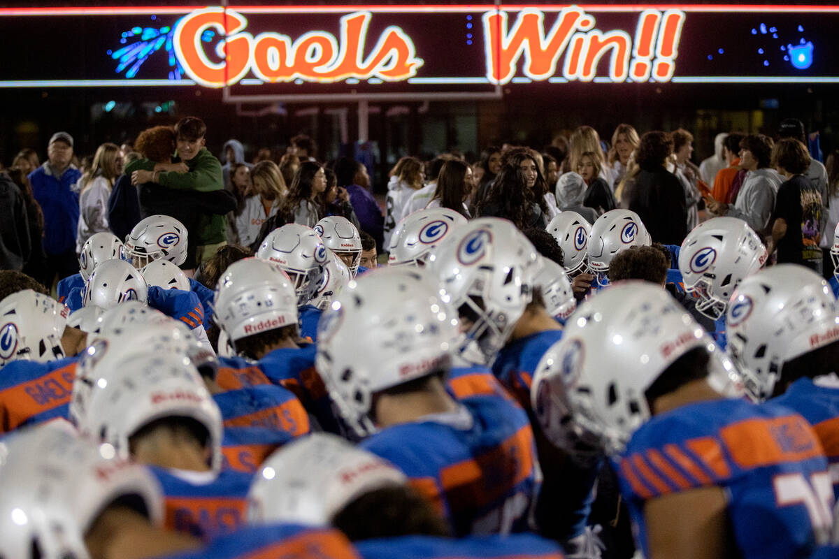 Bishop Gorman bows their heads to pray after winning a high school football game against Faith ...