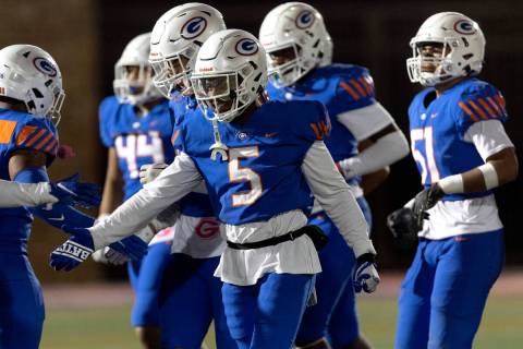 Bishop Gorman’s Jeremiah Vessel (5) reaches to slap hands with teammates after sacking F ...