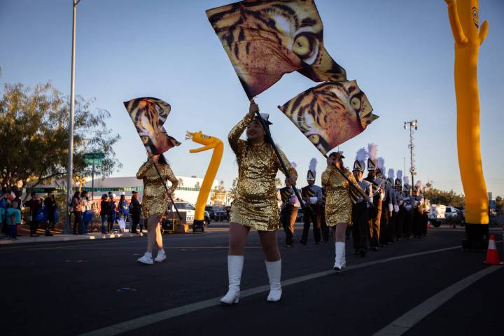 Bonanza High School cheerleaders and marching band members walk in a parade celebrating the Bol ...