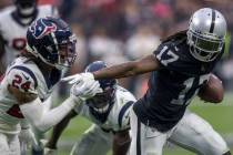 Raiders wide receiver Davante Adams (17) makes a catch with Houston Texans cornerback Derek Sti ...