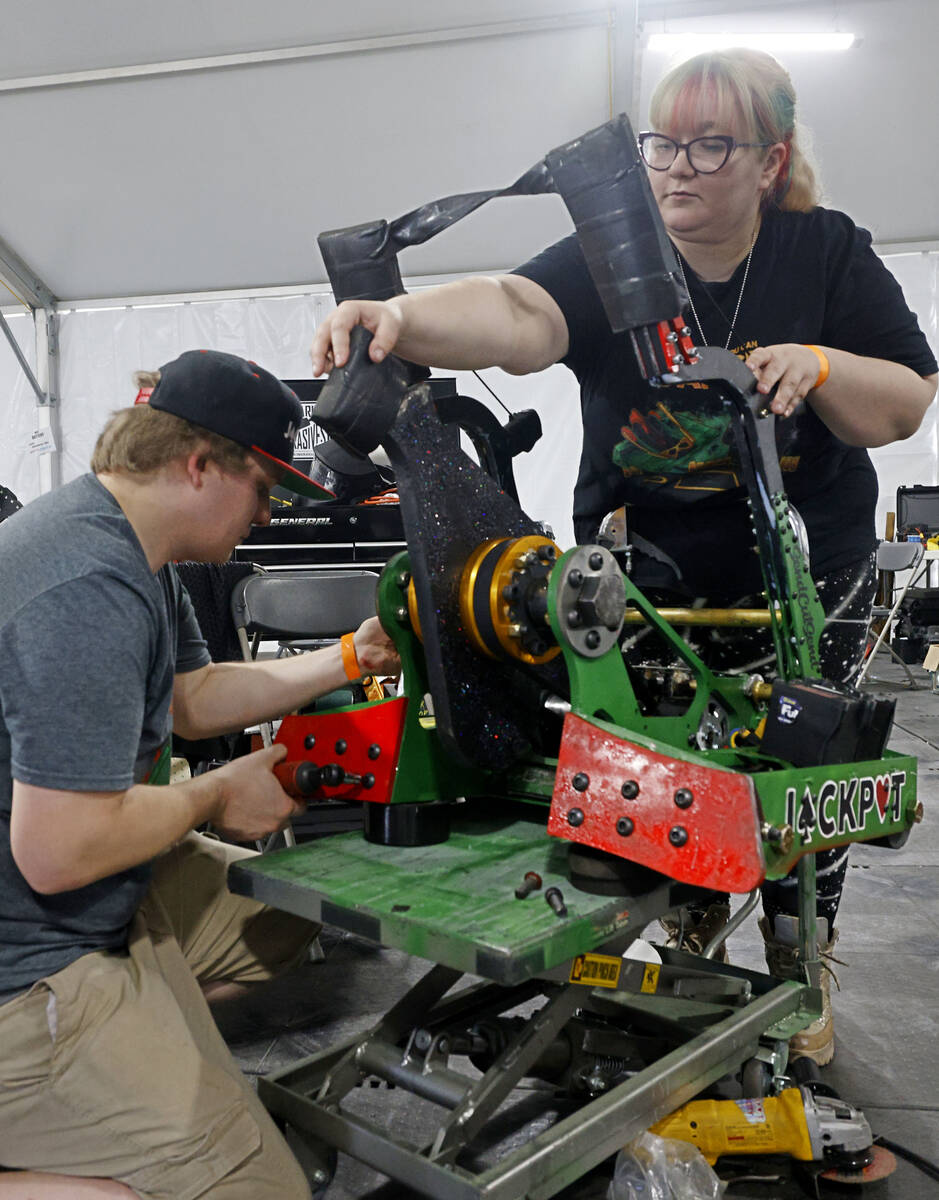 Vegas Combat Robotics team members Lucas Grell and Kat Waters prepare their robot Jackpot for a ...