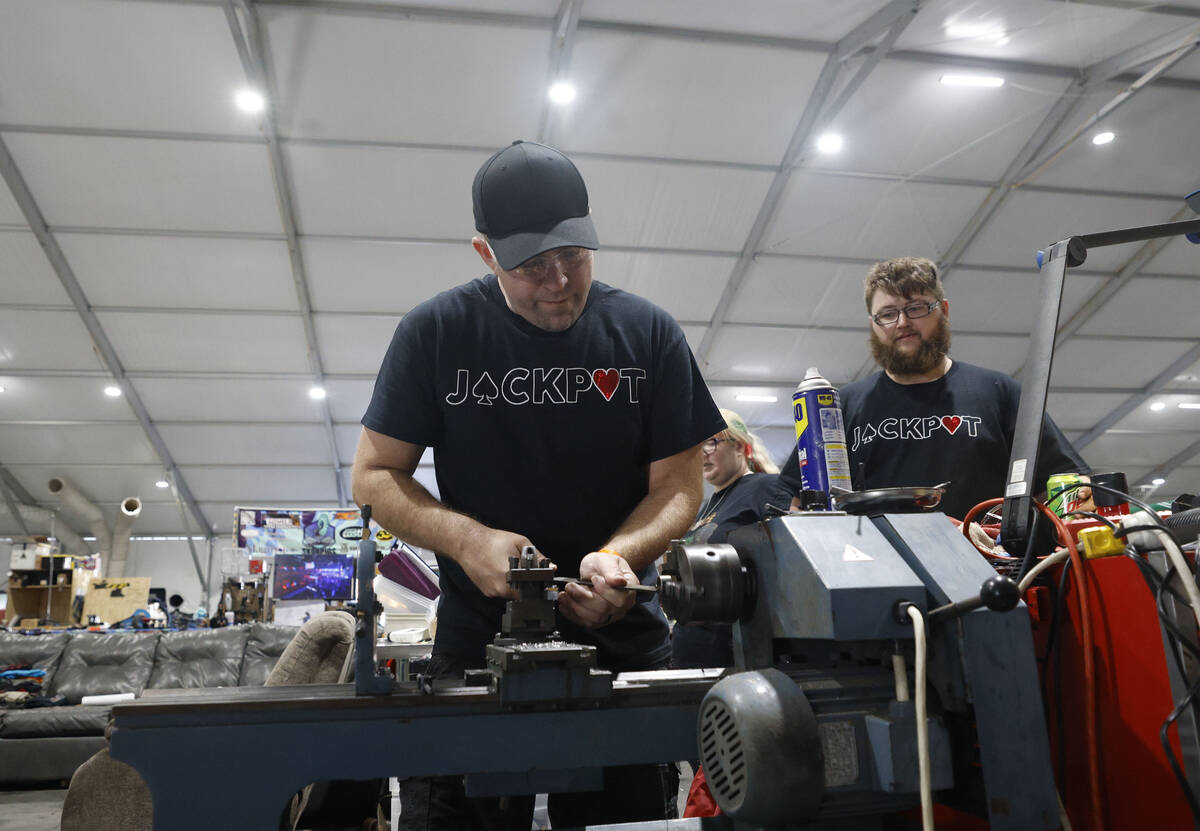 Vegas Combat Robotics team member Jason Woods, left, and the team founder Jeff Waters work in t ...