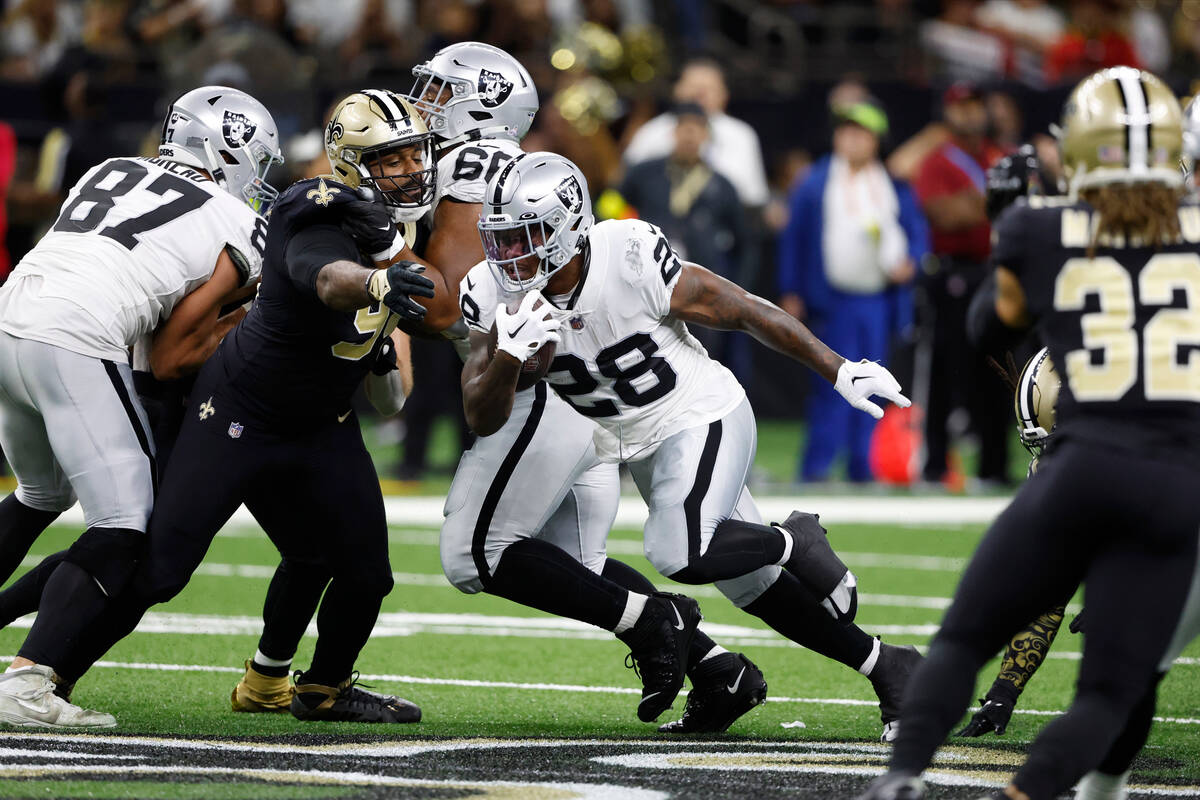 Las Vegas Raiders running back Josh Jacobs (28) runs the ball during the first half of an NFL f ...