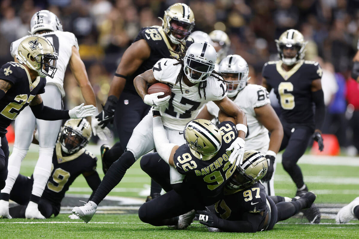 New Orleans Saints defensive ends Marcus Davenport (92) and Malcolm Roach (97) tackle Las Vegas ...