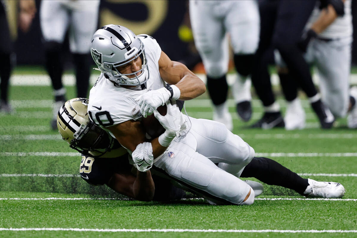 New Orleans Saints cornerback Paulson Adebo (29) tackles Las Vegas Raiders wide receiver Mack H ...