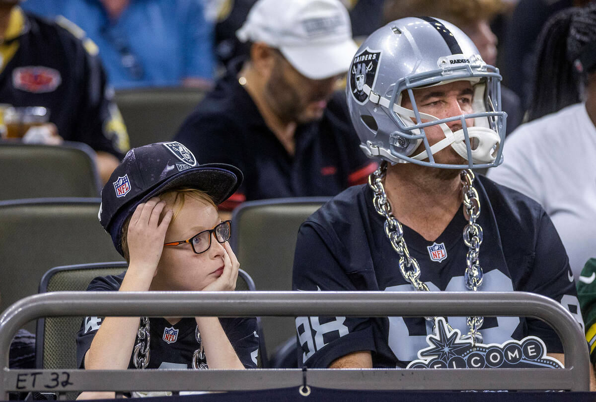 Raiders fans sit dismayed as the New Orleans Saints lead big during the first half of their NFL ...