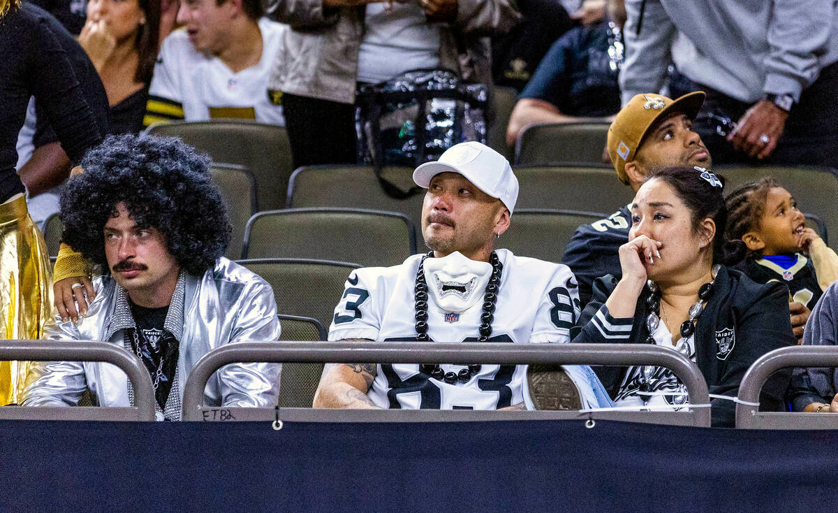 Raiders fans sit dejected as the New Orleans Saints are about to win during the second half of ...