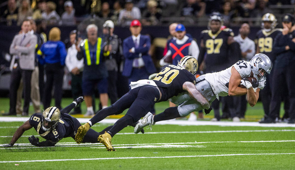 Raiders tight end Foster Moreau (87) extends for a few more yards after a catch as New Orleans ...