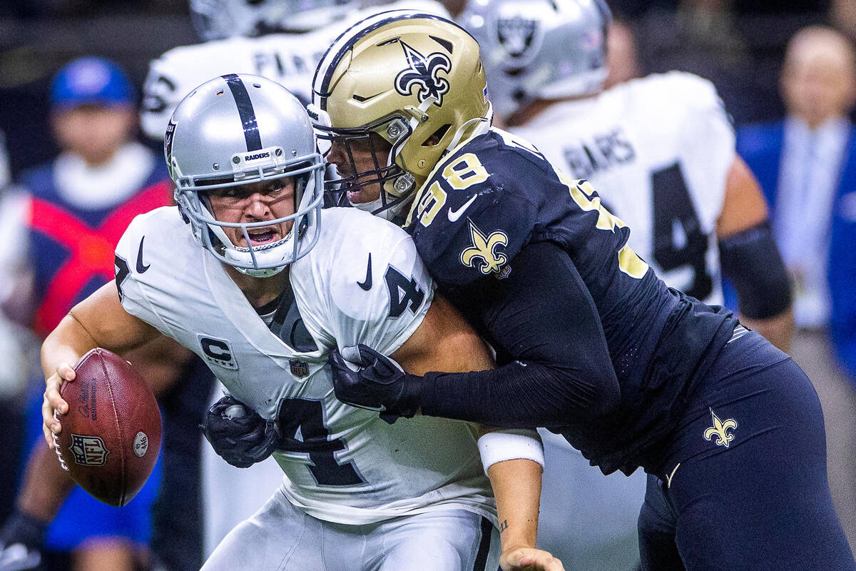 Raiders quarterback Derek Carr (4) is sacked by New Orleans Saints defensive end Payton Turner ...