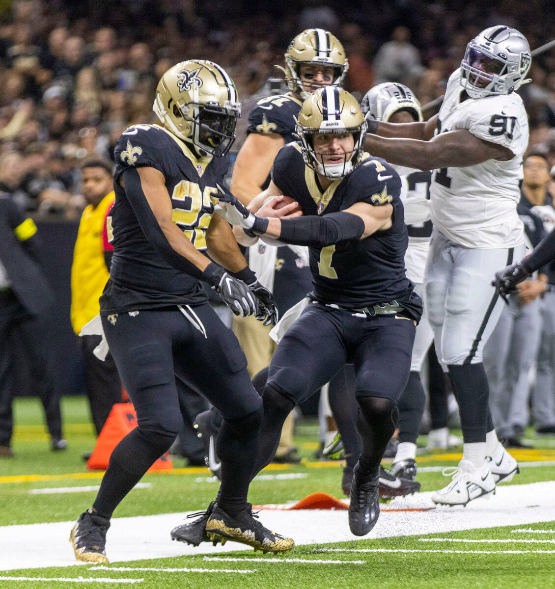 New Orleans Saints tight end Taysom Hill (7) looks for room to run near running back Mark Ingra ...