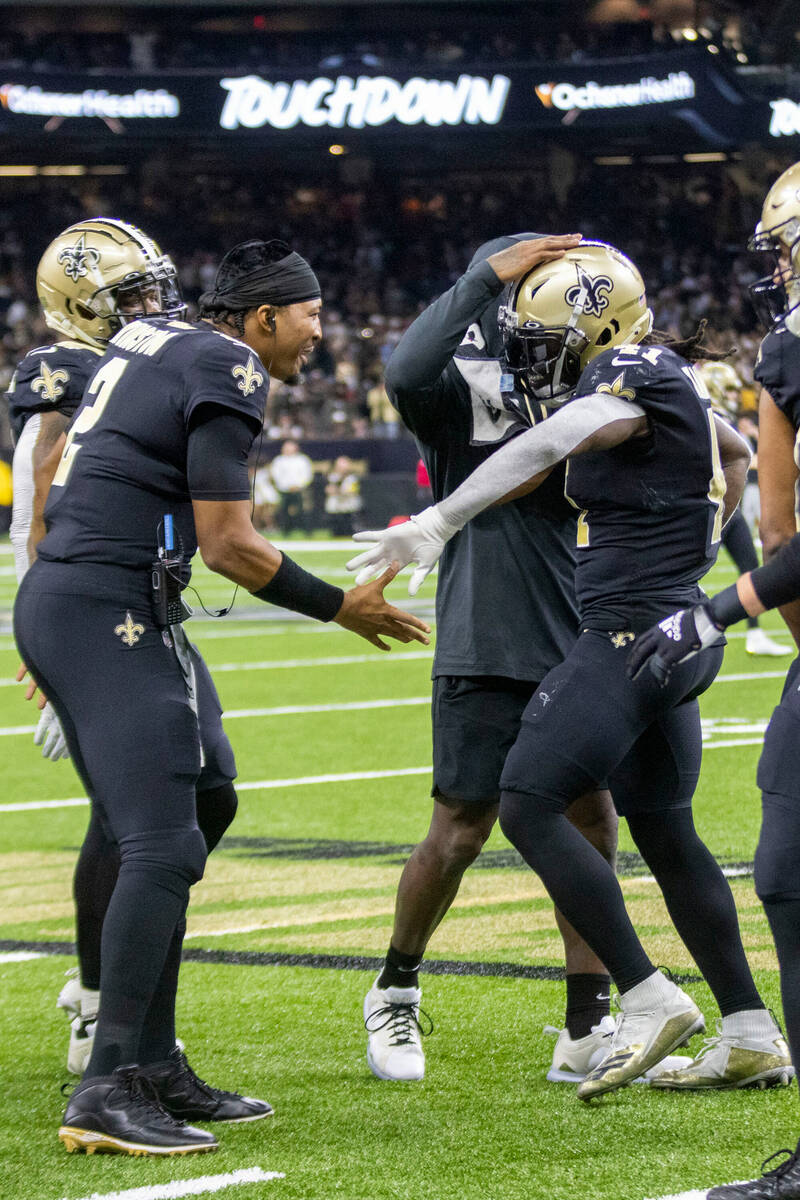 New Orleans Saints running back Alvin Kamara (41) celebrates his touchdown score with quarterba ...