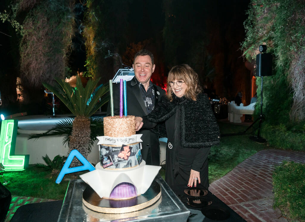 The Neon Museum Executive Director Aaron Berger and honoree Barbara Molasky cut a cake celebrat ...