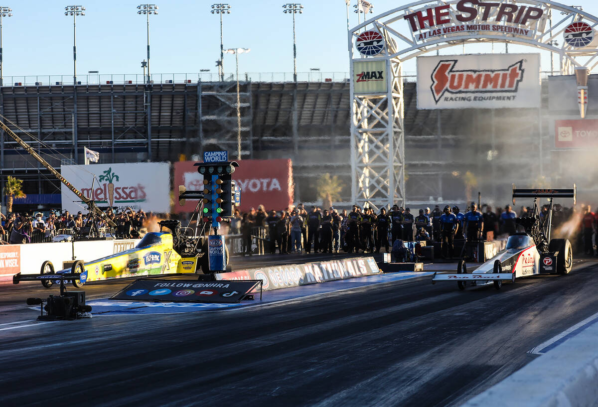 Brittany Force, left, races Mike Salinas, right, for the top fuel NHRA Nevada Nationals at the ...