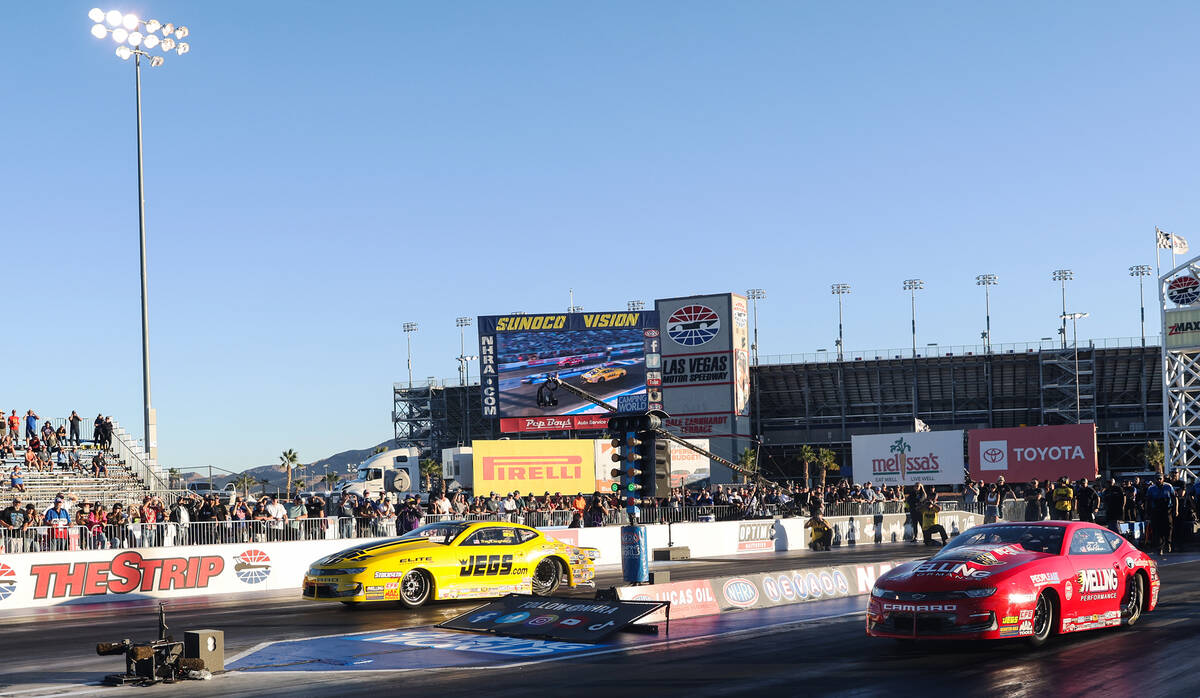 Troy Coughlin Jr., left, races against Erica Enders, right, for the pro stock NHRA Nevada Natio ...