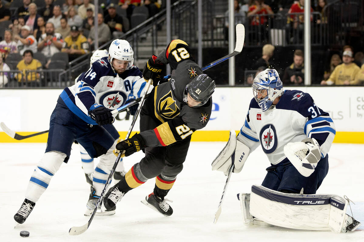 Winnipeg Jets defenseman Josh Morrissey (44) crosschecks Vegas Golden Knights center Brett Howd ...