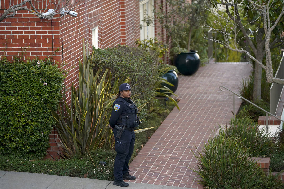 A police officer stands outside the home of House Speaker Nancy Pelosi and her husband Paul Pel ...