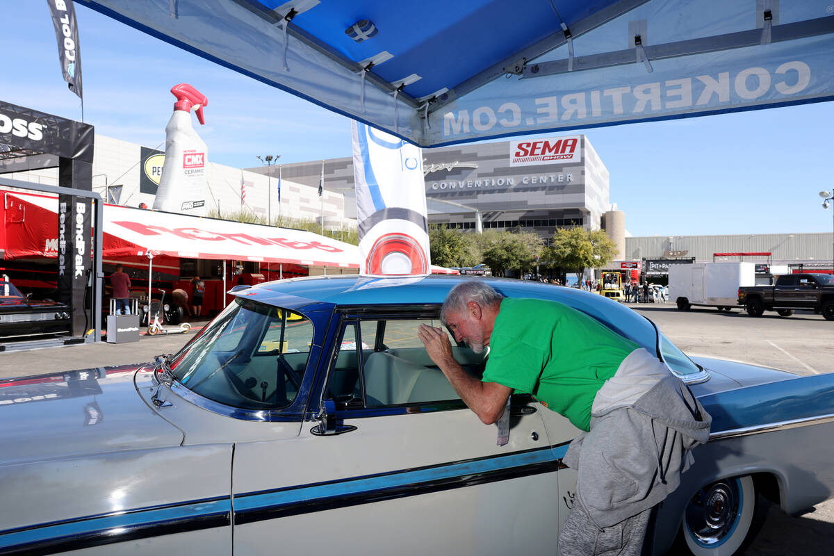 Delbert McGee of Garland, Texas checks out a 56 Chrysler Imperial at the Coker Tire booth ahead ...